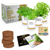 Zestivreens Deluxe Ceramic Herb Garden Kit shown with its retail box, four white ceramic pots with gold bases and leafy herbs, three round brown grow plugs, seed packets, and two instruction cards on a white background.