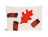 Bar of CHAI TEA SOAP SLICE 5.5 oz. with red and brown abstract design on a white background