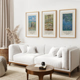 Living room with a white sofa, wooden coffee table, and framed Claude Monet prints on the wall. 3 Piece Claude Monet Wall Art Set. Water Lilies Prints