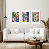 Living room with a white sofa, wooden coffee table, and Modern Colorful Floral Matisse Wall Art Set on the wall.