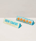 Packaging for 'Grow Comfort' seed balls with a light gray background
