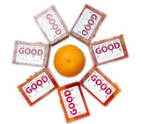 Orange surrounded by 'A Slice of the Good Life' packaging on a white background
