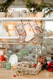 Decorative Christmas stockings hanging on a shelf with festive decor.