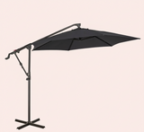 Black patio umbrella with stand on a light beige background