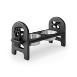 Black pet bowl stand with two stainless steel bowls on a white background