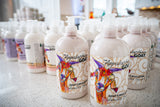 Multiple bottles of 'The Appalachian Goat' lotion on a counter.