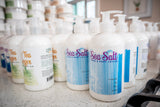 Row of Sea Salt hand and body lotion bottles on a counter.