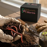 Meme's Worms product packaging with worms and gardening tools on a wooden surface.