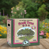 Box of all natural fertilizer for fruit trees on a wooden surface with a garden background