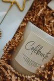 Candle labeled 'Celebrate' on a textured surface