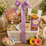 Gift basket with snacks, tea, and flowers on a wooden table Garden of Indulgence Gourmet Gift Basket with Tea & Cookies