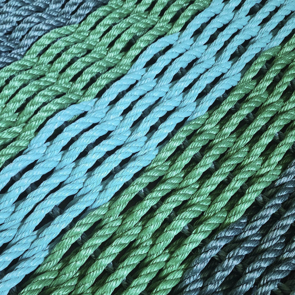 Close-up of green and blue rope on a wooden surface