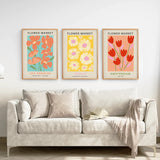 3 Piece Botanical Boho Art Set. Flower Market Theme above a sofa in a living room.