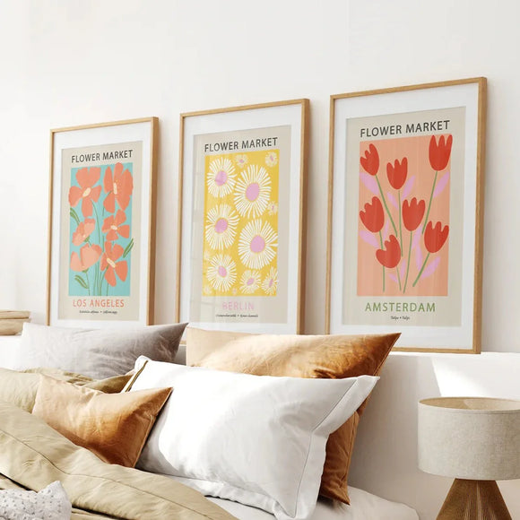 3 Piece Botanical Boho Art Set. Flower Market Theme on a wall above a bed with pillows.