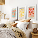 Bedroom with 3 Piece Botanical Boho Art Set. Flower Market Theme on the wall, bed with pillows, and lamps.