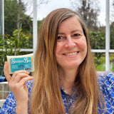 Woman holding a shampoo bar with a natural background