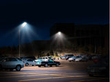 Parking lot at night with streetlights illuminating cars