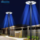 4500W Solar Outdoor Light Round 360° Wide Angle UFO Garden Pole And Wall Street Lights with Remote emitting blue light in front of a building at night.