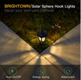 Solar sphere hook light on grass with pavement, featuring Brightown branding.