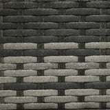 Close-up of a woven pattern with alternating dark and light brown strips