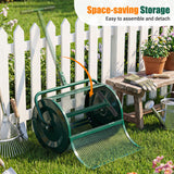 Green garden roller with wheels on grass, white picket fence in background