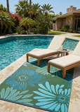Poolside area with lounge chairs and a floral Daisy Aqua & Green rug