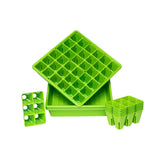 Green plastic seedling trays on a white background