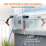 Garden hose reel with 180-degree rotation and easy installation features on a concrete ledge.