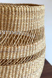 Close-up of a woven basket with a textured pattern on a plain background
