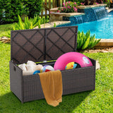 Outdoor storage bench with toys and a towel by a pool