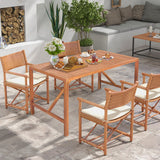 Outdoor patio set with wooden table and chairs on a stone patio.