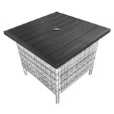Outdoor table with black top and wicker base on a white background