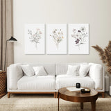 Modern living room with a white sofa, wooden coffee table, and 3 Piece Watercolor Floral Wall Art Set