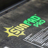 Close-up of a product packaging with 'SunRad Pro' branding on a dark surface.