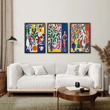 Living room with a white sofa, wooden coffee table, and Modern Colorful Floral Matisse Wall Art Set on the wall.