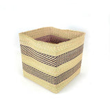 Woven storage basket with striped pattern on a white background