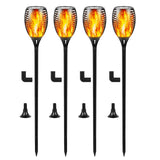Four solar garden lights with flame-like design on black stakes, with additional stakes below.