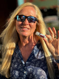 Woman wearing sunglasses and holding PEPPERMINT JOY LUXURY LIP BUTTER™ - THE APPALACHIAN GOAT