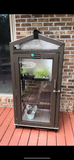 Janco Indoor/Outdoor Garden Cabinet on a deck with brick wall background