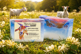 Appalachian Goat soap bar with packaging in a field with sheep in the background