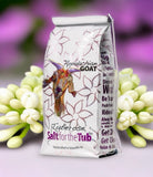 Appalachian Goat salt for the tub packaging with flowers in the background