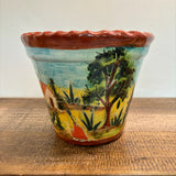 Casita Talavera Pot with a scenic hand-painted design on a wooden surface