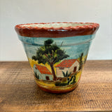 Casita Talavera Pot with a scenic painting on a wooden surface