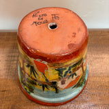 Casita Talavera Pot with colorful designs and 'Hecho en Mexico' text on a wooden surface.
