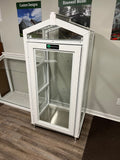 White Janco Indoor/Outdoor Garden Cabinet on a wooden floor with promotional signs in the background.