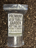 Bag of premium vegetable garden potting mix on a dark soil background