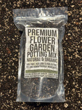 Package of premium flower garden potting mix on a dark, textured surface
