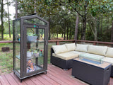 Outdoor patio with Janco Indoor/Outdoor Garden Cabinet, sectional sofa, fire pit table, and glass-enclosed pet habitat.