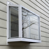Janco Garden Window with screen on a beige siding wall