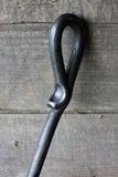Blacksmith-made Wood Stove Fire Poker on a wooden background